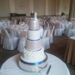 White Ruffles with blue ribbon wedding cake